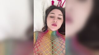 Louisa Khovanski teases in rainbow fishnet outfit