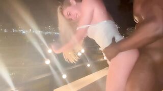 Blonde-Slut-Takes-Huge-BBC-in-her-Throat-and-Gets-Railed-on-the-Railing-of-her-Balcon